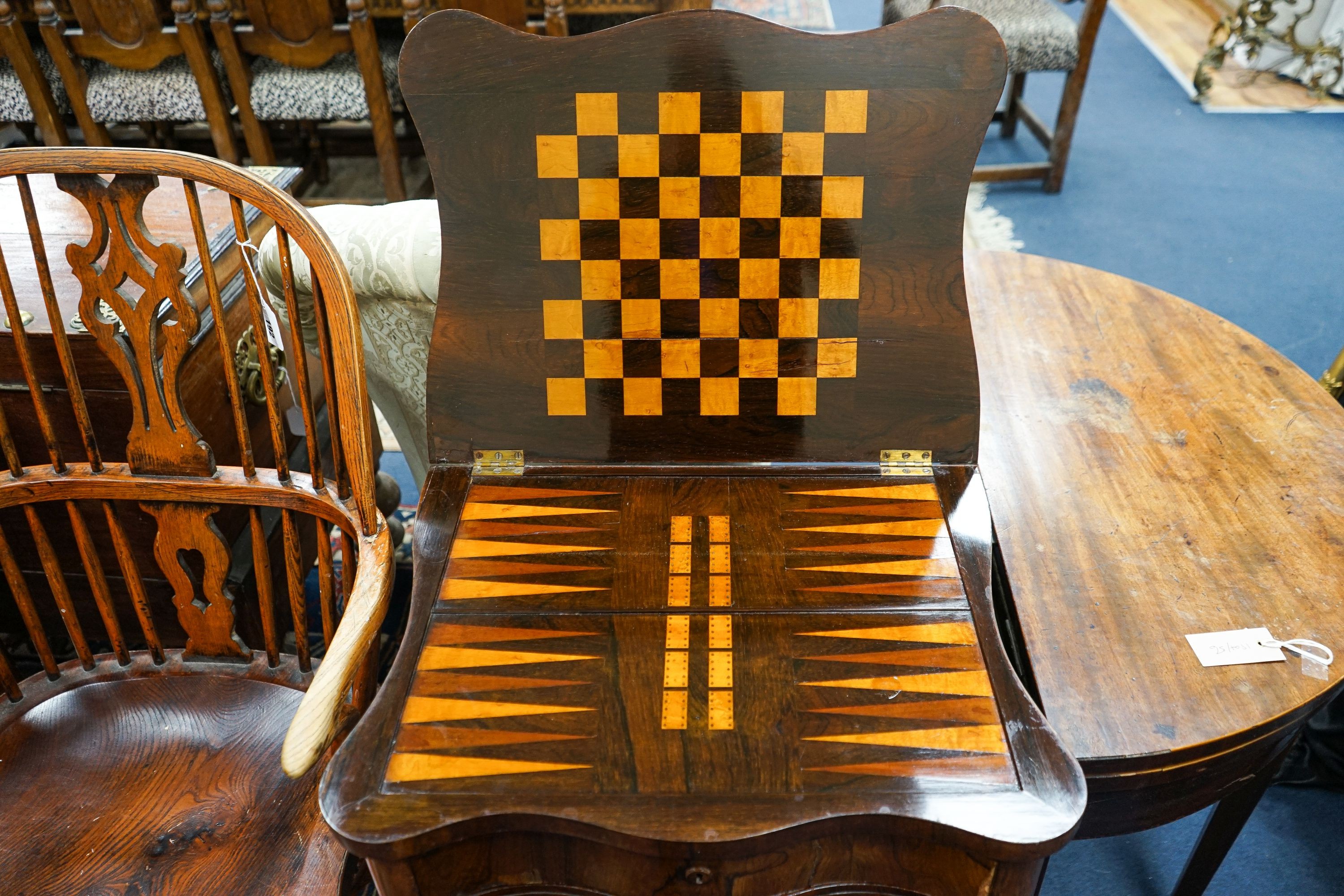 A Victorian rosewood serpentine games / work table with parquetry inlaid interior, width 55cm, depth 42cm, height 76cm